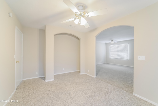 carpeted spare room with ceiling fan