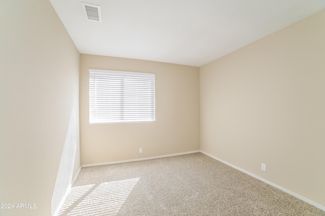 spare room with light colored carpet