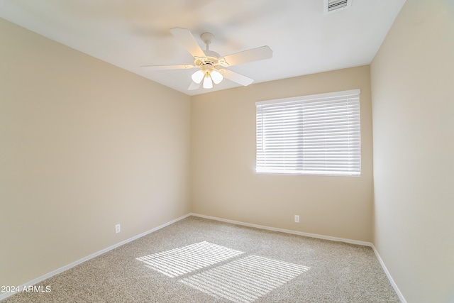 spare room featuring carpet and ceiling fan