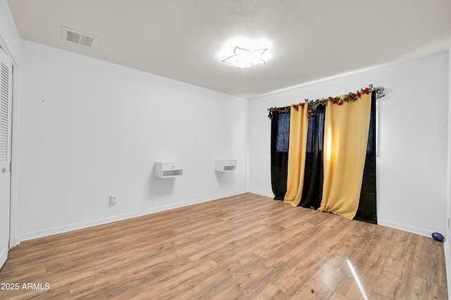 unfurnished room with hardwood / wood-style floors