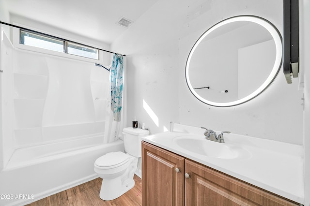 full bathroom with hardwood / wood-style flooring, vanity, shower / bath combination with curtain, and toilet