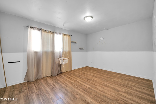 spare room with hardwood / wood-style floors