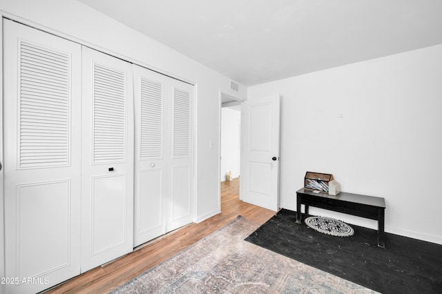 bedroom featuring light hardwood / wood-style floors and a closet