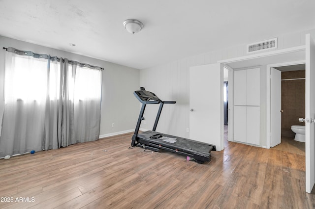 workout area with hardwood / wood-style flooring