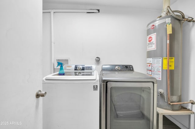 washroom featuring gas water heater and washer and dryer