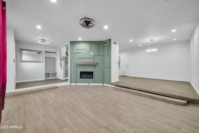 unfurnished living room with light hardwood / wood-style flooring