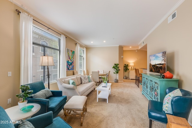 carpeted living room featuring baseboards, ornamental molding, visible vents, and recessed lighting