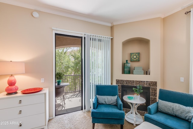 living area with a tiled fireplace, carpet flooring, and crown molding