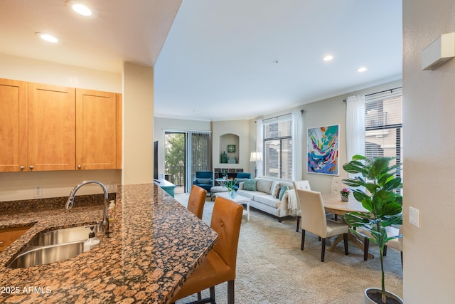 interior space featuring ornamental molding, recessed lighting, and light carpet