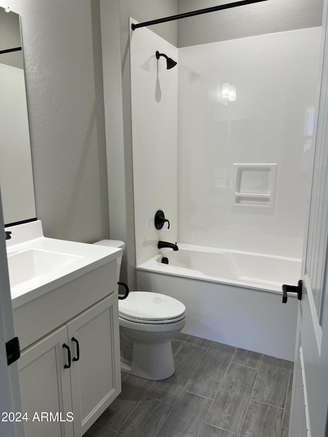 full bathroom with shower / tub combination, vanity, and toilet