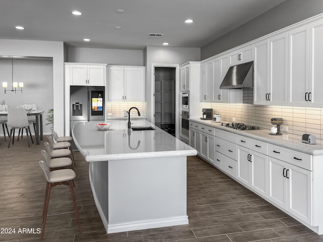 kitchen with sink, white cabinets, and ventilation hood