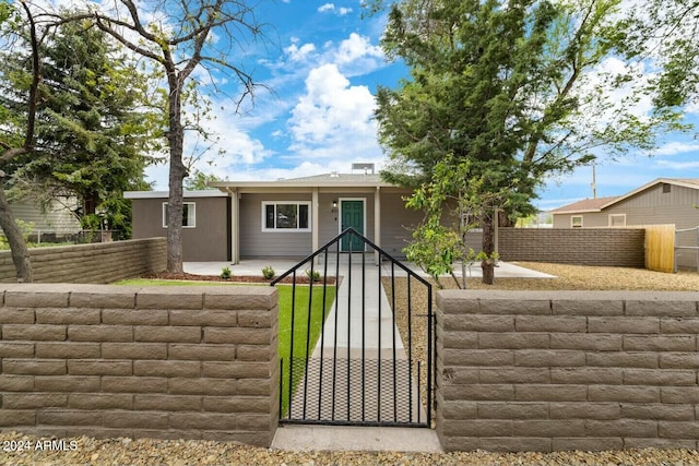 view of front of home featuring a fenced front yard and a gate