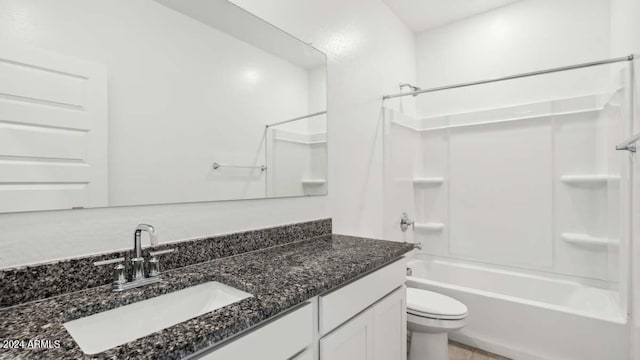 full bathroom featuring toilet, vanity, and  shower combination