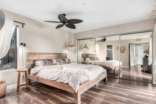 bedroom with hardwood / wood-style floors, ceiling fan, and a closet