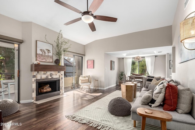 living room with a tiled fireplace, ceiling fan, dark hardwood / wood-style flooring, and lofted ceiling