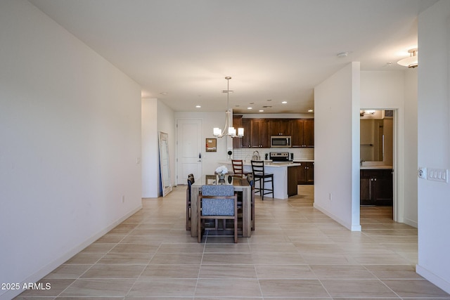dining area featuring recessed lighting, baseboards, light tile patterned floors, and an inviting chandelier