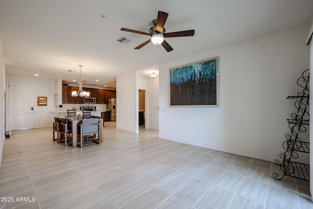 living room featuring ceiling fan with notable chandelier, recessed lighting, and visible vents