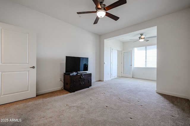 unfurnished living room featuring carpet floors, ceiling fan, and baseboards