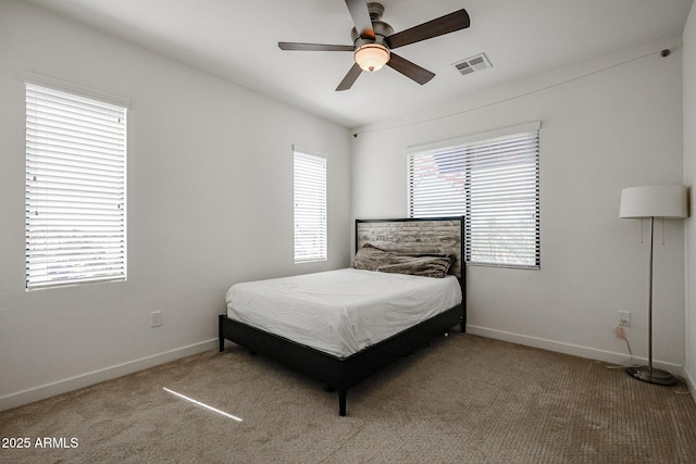 bedroom featuring visible vents, a ceiling fan, baseboards, and carpet floors