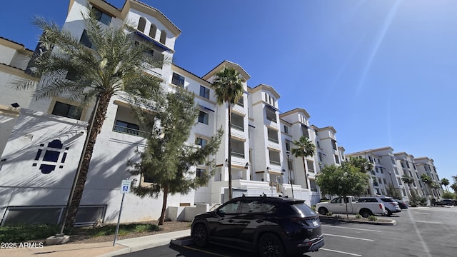 view of property featuring a residential view and uncovered parking