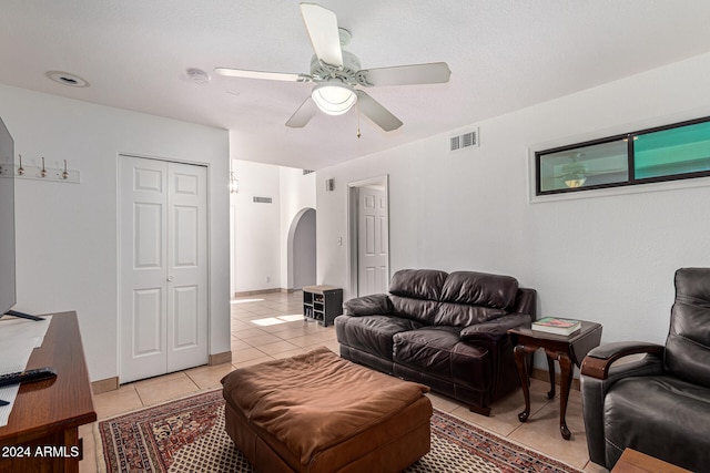 tiled living room featuring ceiling fan