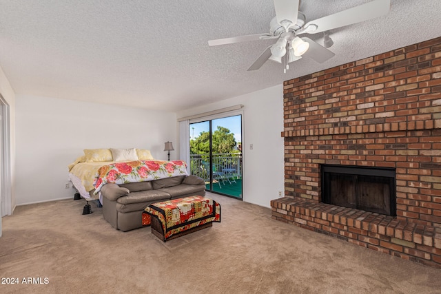 living room featuring a fireplace, light colored carpet, and a textured ceiling