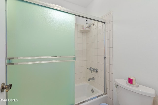 bathroom featuring toilet and enclosed tub / shower combo