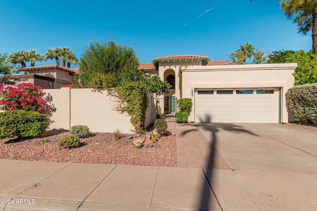 mediterranean / spanish-style home featuring a garage