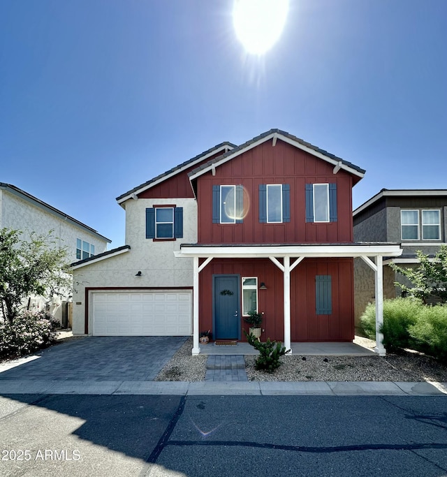 15718 W Polk St, Goodyear, AZ 85338 - traditional home with board and batten siding, an attached garage, driveway, and covered porch