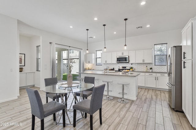 15718 W Polk St, Goodyear, AZ 85338 - dining space with recessed lighting and light wood-type flooring