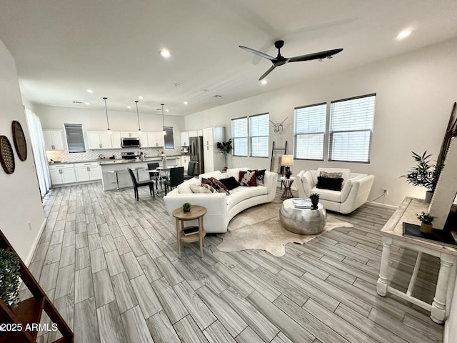 15718 W Polk St, Goodyear, AZ 85338 - living area featuring ceiling fan, recessed lighting, wood finish floors, and baseboards