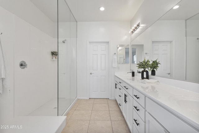 15718 W Polk St, Goodyear, AZ 85338 - bathroom featuring double vanity, tile patterned flooring, walk in shower, and recessed lighting