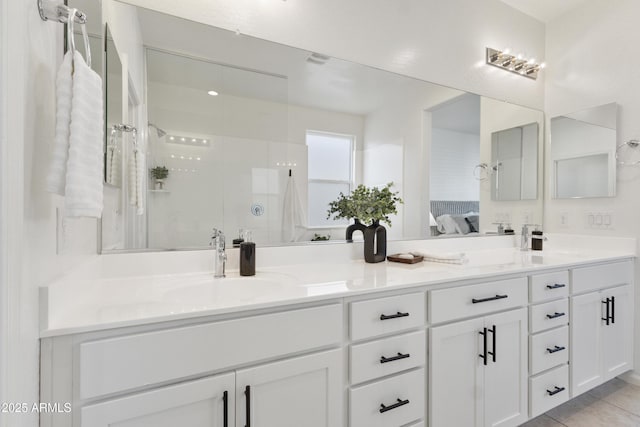 15718 W Polk St, Goodyear, AZ 85338 - full bathroom featuring ensuite bathroom, double vanity, a walk in shower, and tile patterned flooring