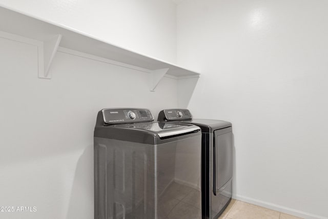 15718 W Polk St, Goodyear, AZ 85338 - laundry room with washing machine and clothes dryer, light tile patterned floors, and baseboards