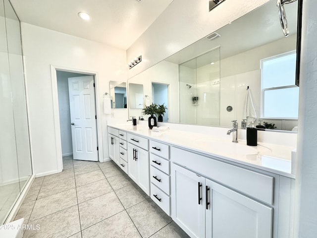 15718 W Polk St, Goodyear, AZ 85338 - bathroom with a stall shower, double vanity, tile patterned floors, and baseboards