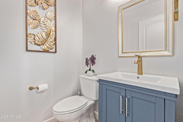 bathroom with toilet and vanity