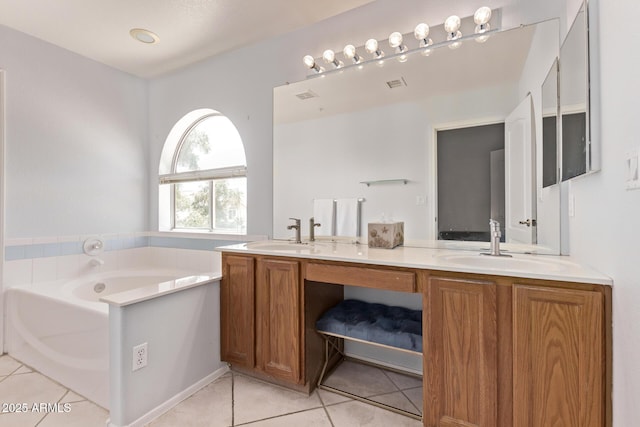 bathroom featuring visible vents, double vanity, a bath, tile patterned floors, and a sink