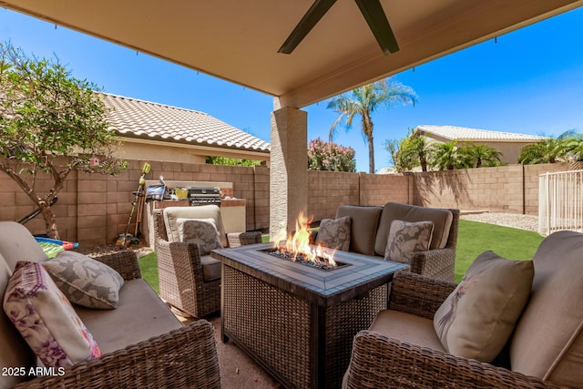 view of patio / terrace featuring a fenced backyard, an outdoor living space with a fire pit, and a ceiling fan