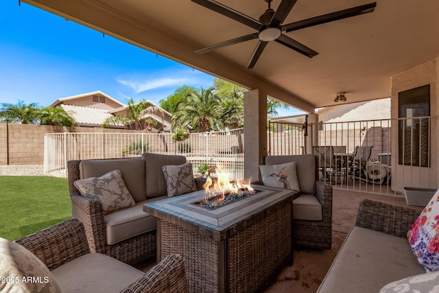 view of patio with a fenced backyard, an outdoor living space with a fire pit, and a ceiling fan