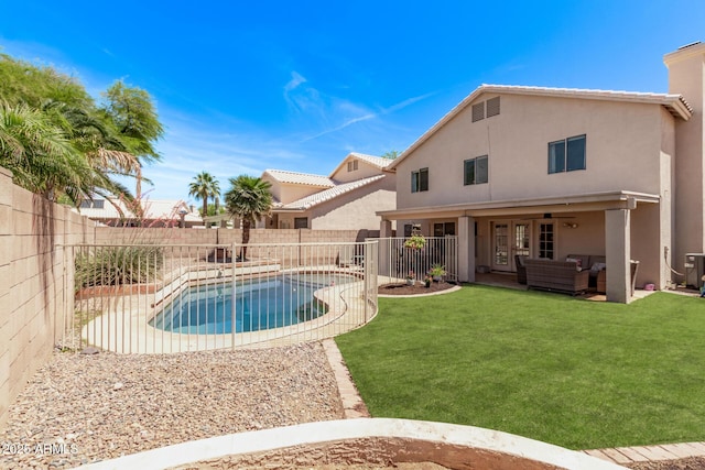 view of swimming pool featuring ceiling fan, a lawn, a patio area, an outdoor hangout area, and a fenced backyard