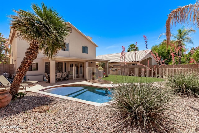 view of swimming pool featuring fence, french doors, a patio area, and a fenced in pool