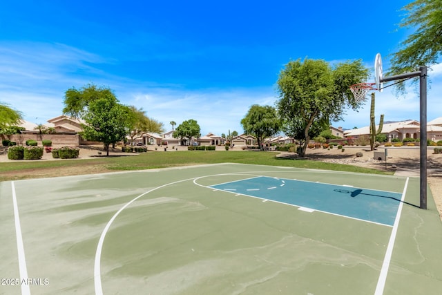 view of basketball court with a residential view, community basketball court, and a yard