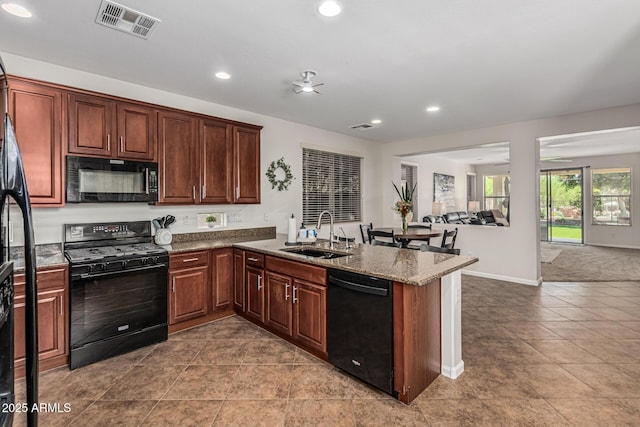 5437 W Red Bird Rd, Phoenix, AZ 85083 - kitchen featuring black appliances, a peninsula, open floor plan, recessed lighting, and tile patterned floors