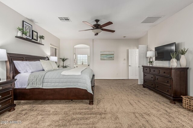 5437 W Red Bird Rd, Phoenix, AZ 85083 - bedroom with light colored carpet, arched walkways, and a ceiling fan