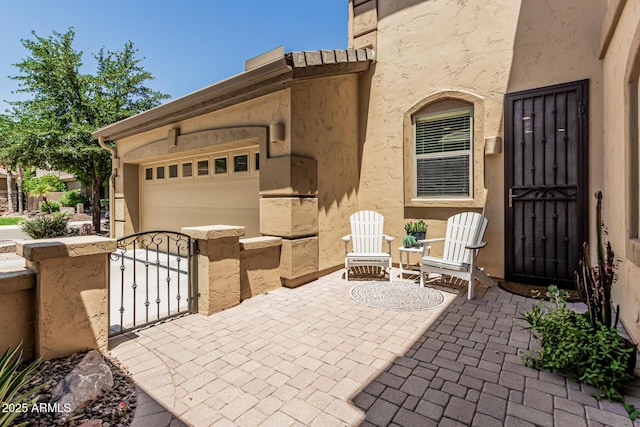 5437 W Red Bird Rd, Phoenix, AZ 85083 - view of patio / terrace featuring an attached garage, a gate, and a fenced front yard