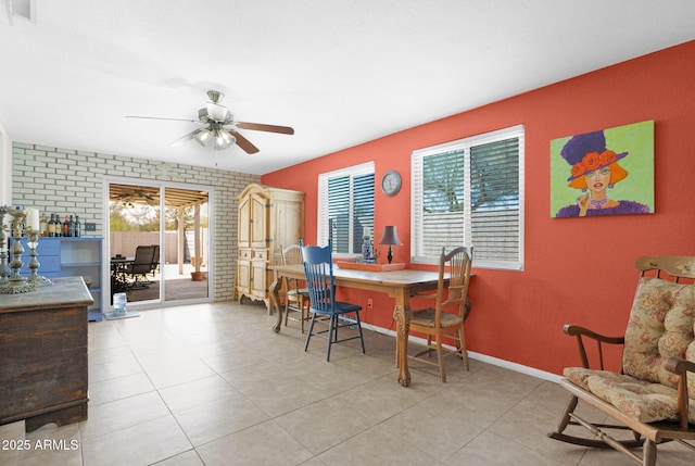 tiled dining area with visible vents, baseboards, and ceiling fan