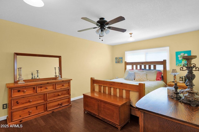 bedroom featuring dark wood-style floors, ceiling fan, and baseboards