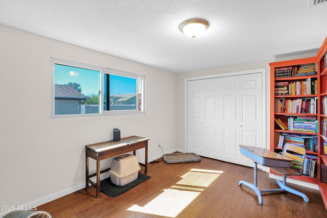 office space with wood finished floors, baseboards, and a textured ceiling