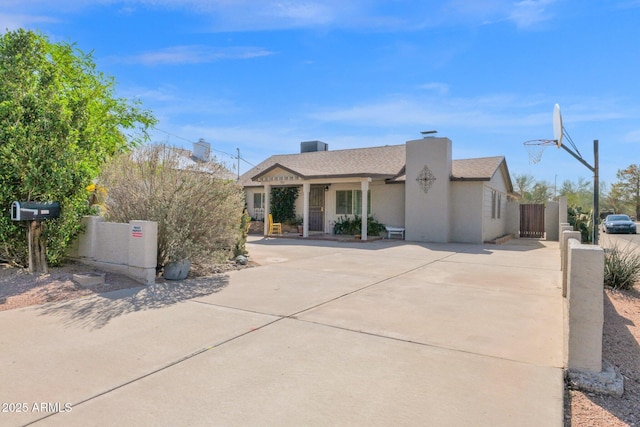 view of front facade with a gate, fence, and driveway