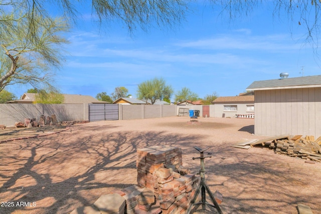 view of yard featuring fence and a gate